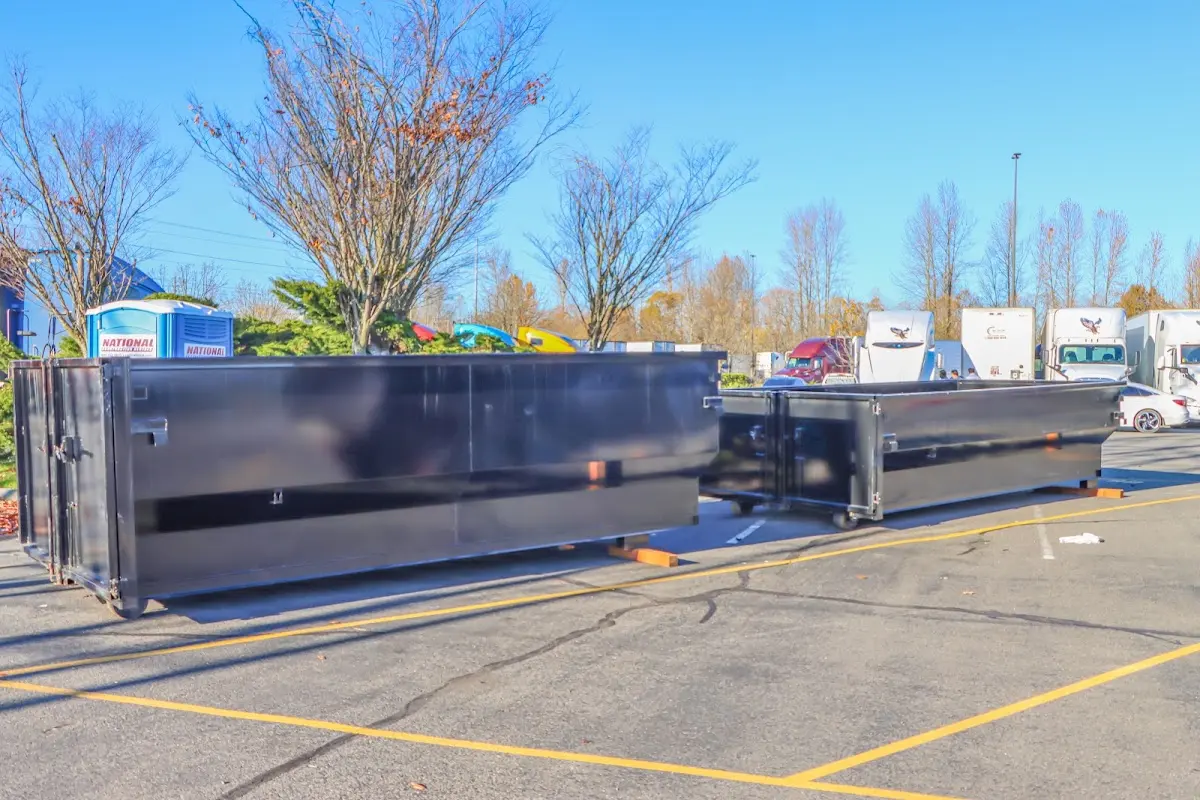 Professional dumpster rental service with roll-off container on residential driveway in New Brighton